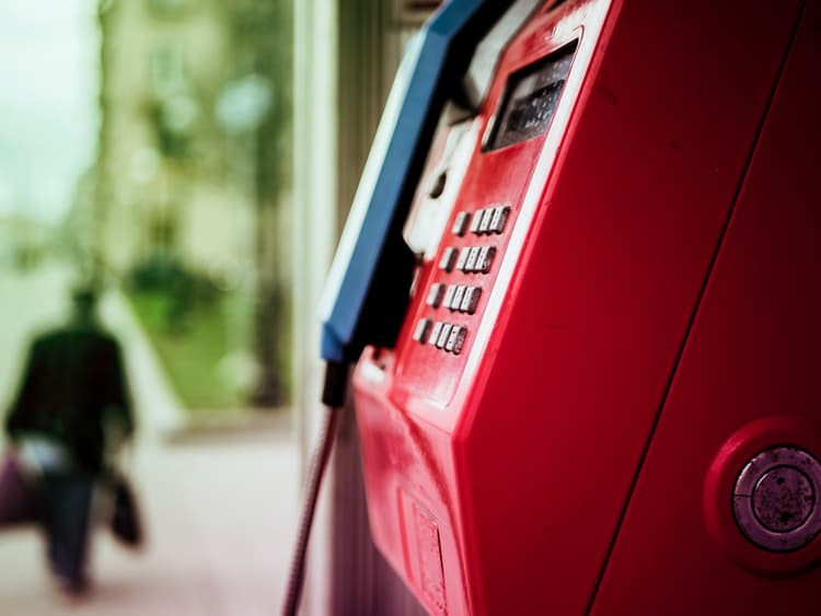 Public phone, red mailbox, old town of the historic city, miniature logos of the languages of the programming environment and frameworks 